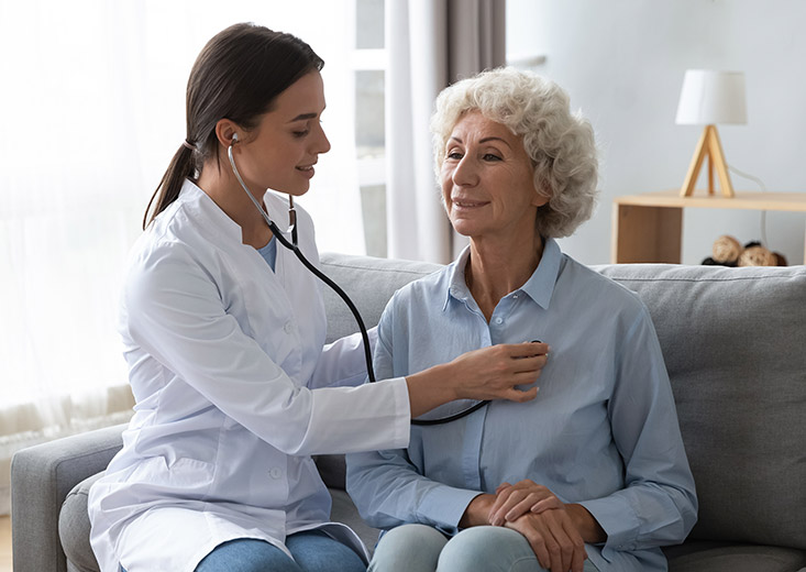 student nurse listening to a patients heart